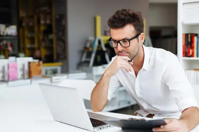 man reviewing financial information on computer