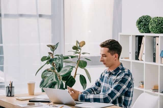 man reviewing investments on smartphone