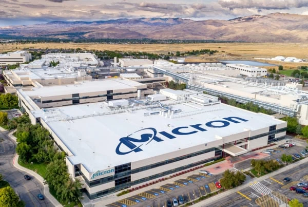 a micron technology facility in boise idaho shot from far away with the mountains in the background.