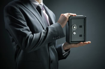 a businessman protects his savings in the safe.
