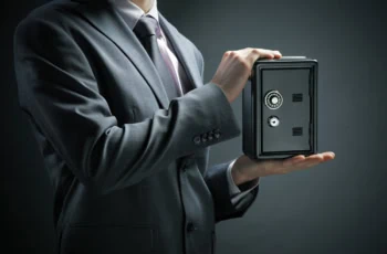 a businessman protects his savings in the safe.