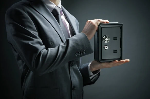 a businessman protects his savings in the safe.