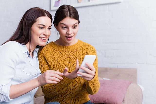 mother mom daughter kid teen smartphone couch living room 2