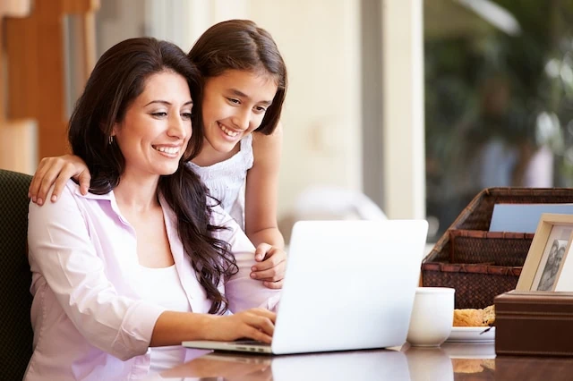 mother teen kid daughter laptop table