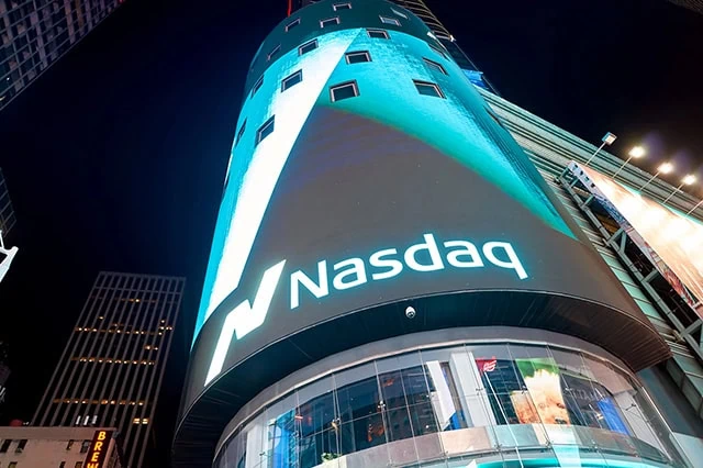 10 Best Low-Cost Fidelity Index Funds to Buy Now 9 the nasdaq sign at night.
