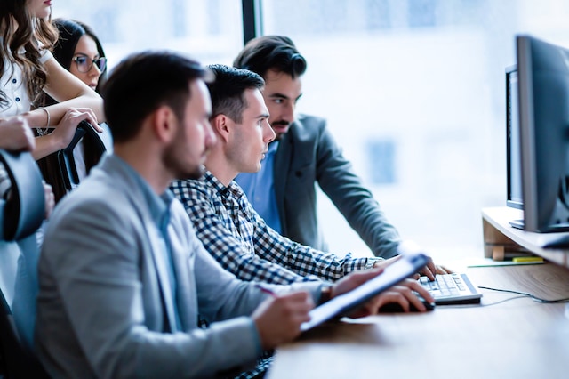 Young businesspeople working on computer in modern office