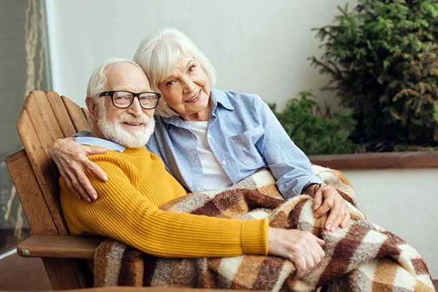 Am I Too Old for a Roth Conversion? 9 an older couple sits together under a blanket.