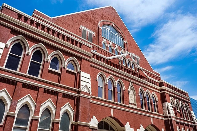 Facade of the historical Ryman Auditorium and Grand Ole Opry music venue in the downtown district.