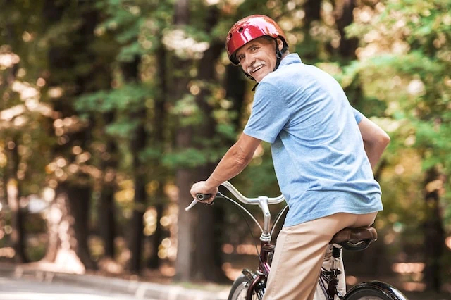 Riding on Bicycle. Smiling Grandfather