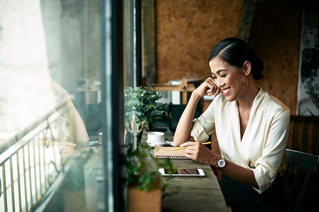 smiling woman writing notes