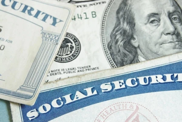 social security cards laid over money