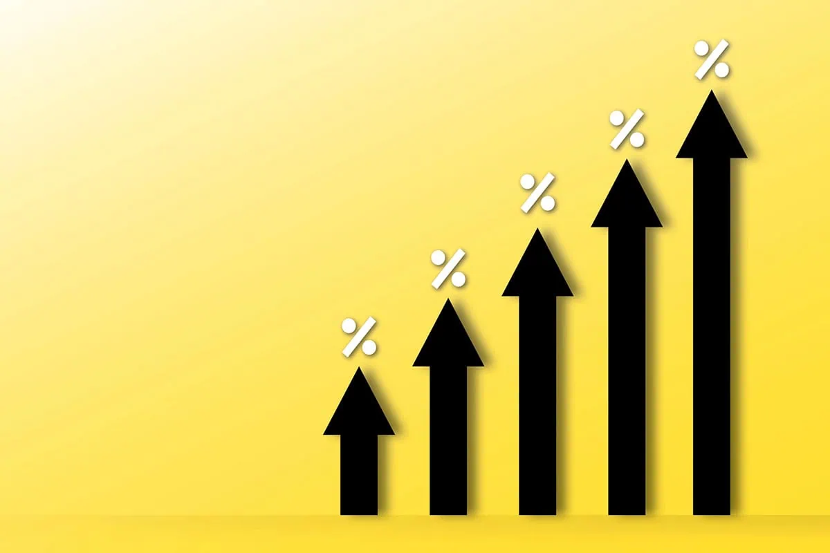 Wall Street Loves These 10 Dividend-Growth Stocks 2 black arrows pointing up against a yellow background.