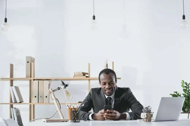 successful man looking at phone medium