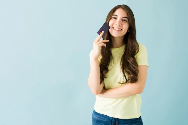 teen girl smiling with card in hand