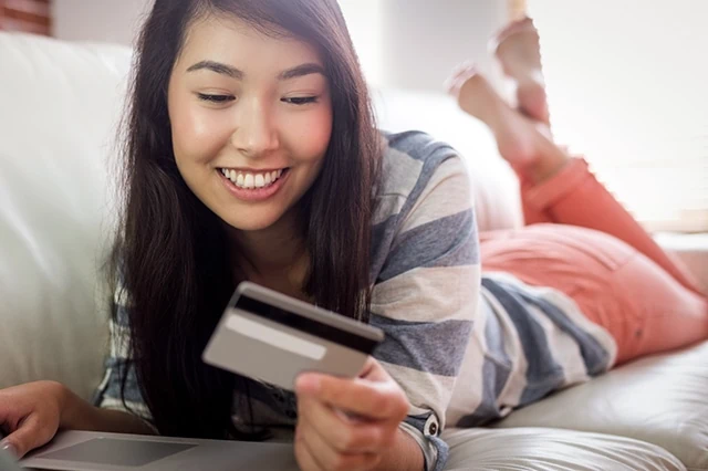 teen young woman couch card smiling relaxed