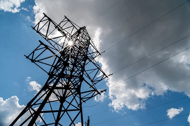 7 Best Fidelity Funds to Hold in an HSA 8 an electric utility tower and lines against a partly cloudy sky.