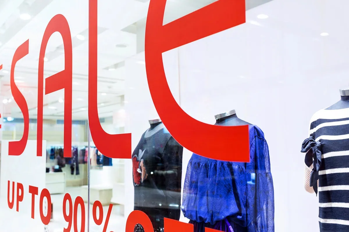 The 16 Best ETFs to Buy for a Prosperous 2026 13 a very close up sale sign in a retail clothing store.