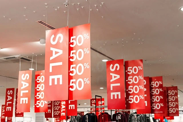 The 10 Best Vanguard Index Funds to Buy in 2026 8 a number of large sale sign banners hanging from the ceiling.