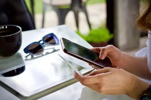 woman buying online on smartphone with credit card