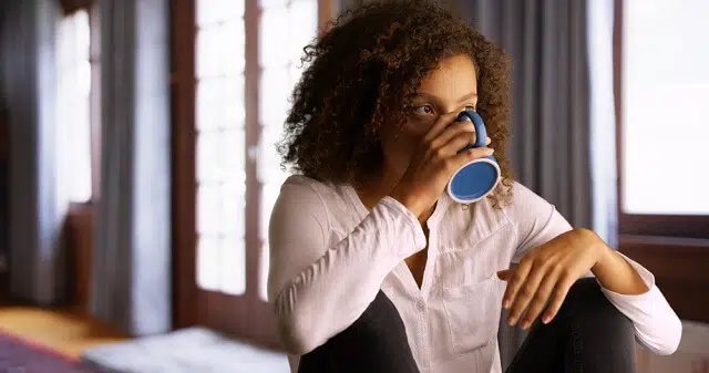 woman contemplating over cup of coffee