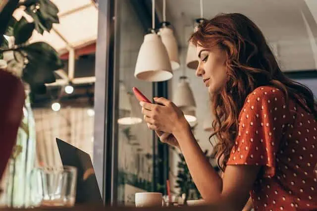 woman in cafe on smartphone