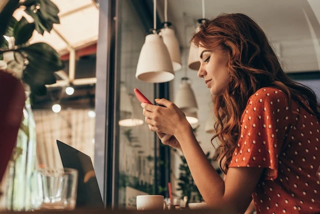 woman in cafe on her phone