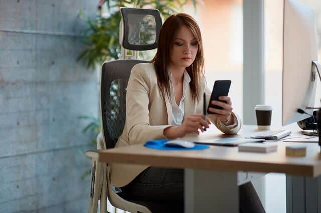 woman looking at her smartphone intently