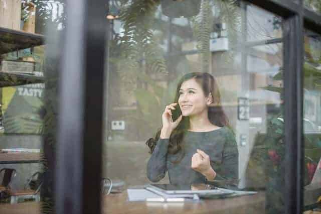 woman-on-phone-celebrating-victory