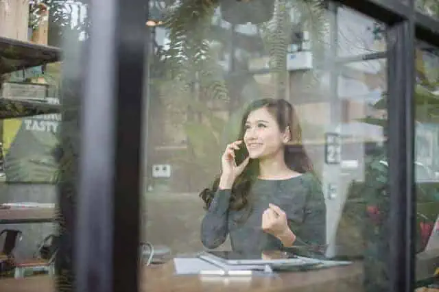woman on phone celebrating victory 1