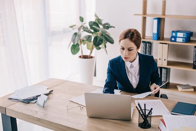 woman reviewing financial documents on computer