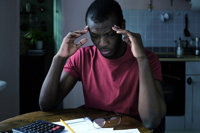 worried man taxes rent late payments bills