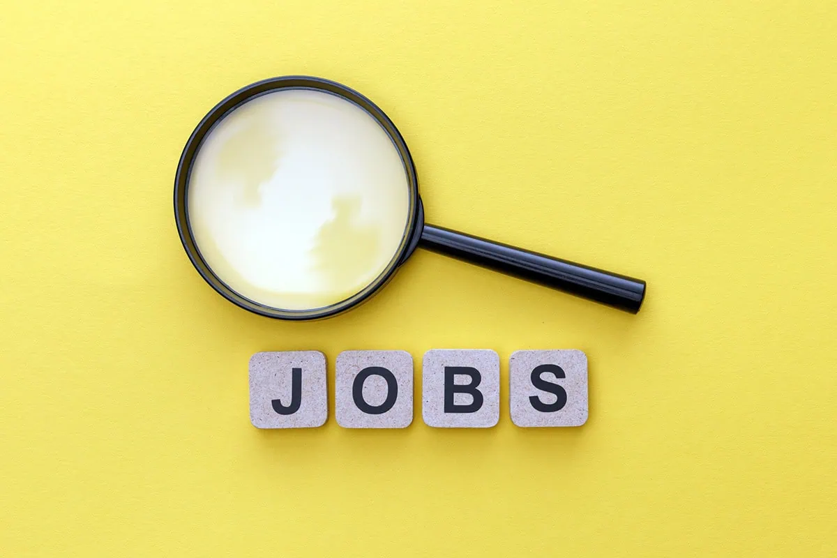 the word jobs is written out in block letters. above the word is a magnifying glass.