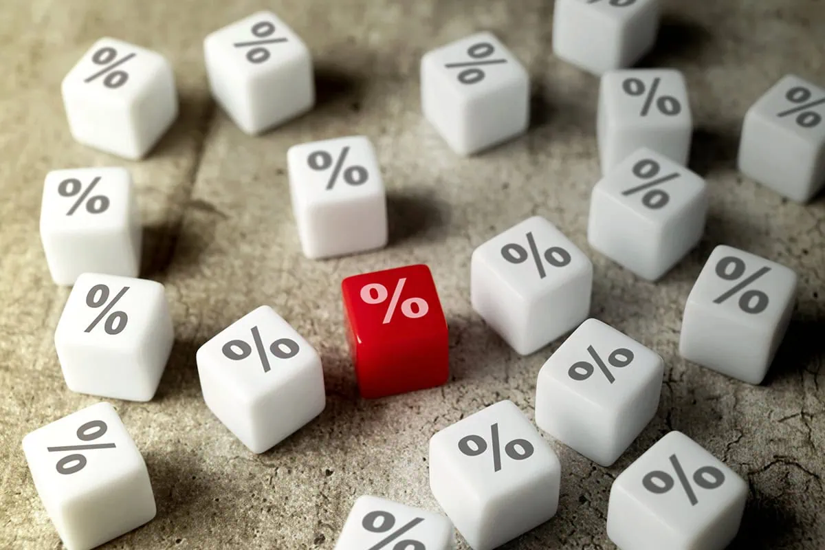 Wall Street Loves These 10 Dividend-Growth Stocks 16 several white dice with percent signs on them and one red die with a percent sign that stands out.