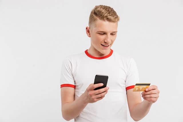 young man with credit card and phone