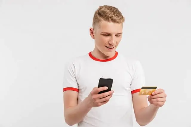 young man with credit card and phone