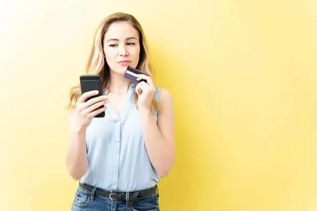 young woman considering credit card purchase