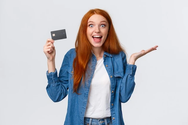 young woman credit debit card smiling white background