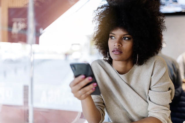 young woman smartphone thinking